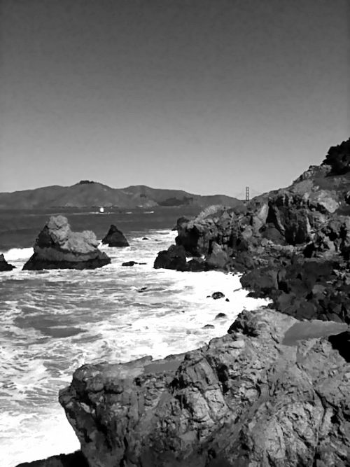 Rocky shore with Golden Gate Bridge in the distance