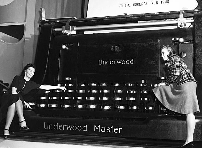 Two women lounge on a  giant typewriter at The World's Fair in 1940