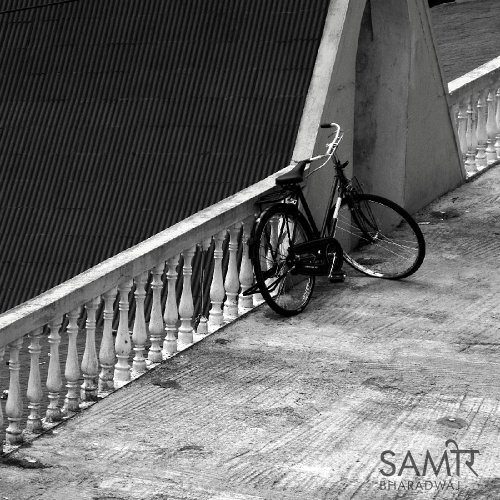 Bicycle leaning against a long decorative balustrade