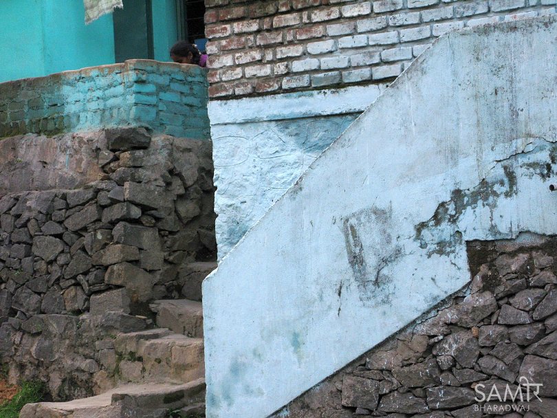Woman hidden behind layered stone stairways