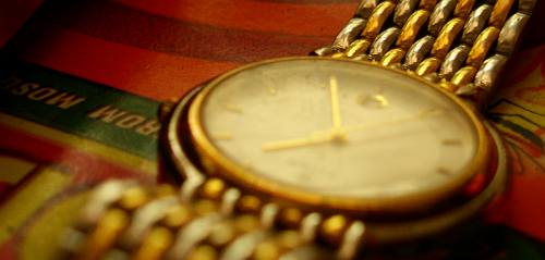 macro photo of a golden metal wrist watch